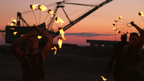 Fire-dancers-against-sunset.-A-young-woman-poses-with-her-fire-hoop-against-the-sunset-during-her-dance-performance
